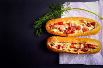 Sausage, tomato and cheese bread boats