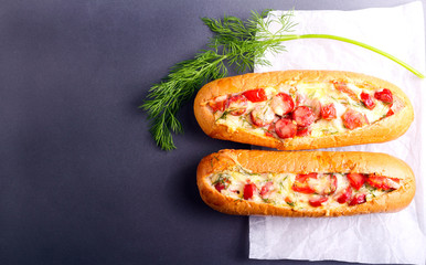 Sausage, tomato and cheese bread boats
