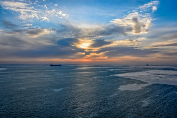 Cargo ship sailing on sunrise