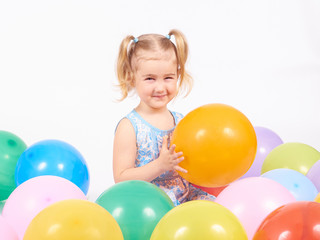 Fototapeta na wymiar Little girl playing with balloons.