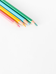Closeup of Colour pencils on white background, selective focus