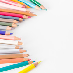 Closeup of Colour pencils on white background, selective focus