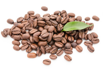 Coffee grains and leaves isolated on the white backgrounds.