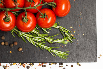 branch of cherry ripe tomatoes, fresh rosemary, allspice, food photography