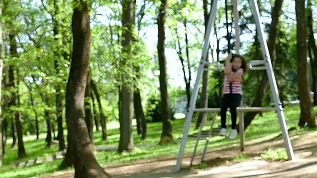 Slow motion of a cute young girl goes zip lining