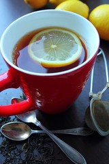 Hot tea with lemon in red mug