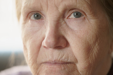 portrait of senior woman in living room, shallow focus photo