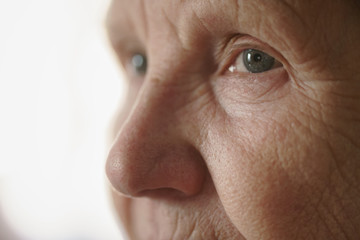 portrait of senior woman in living room, shallow focus photo