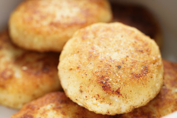prepared fried fish cakes in bowl, shallow focus