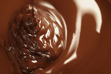 melted dark chocolate flows closeup, shallow focus