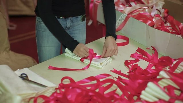 Girls decorate festive napkins with ribbons and flowers. close up