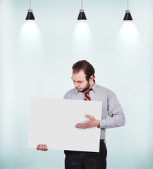 businessman holding blank poster