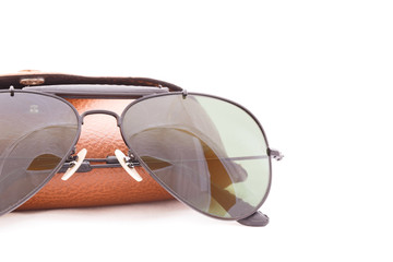 Sunglasses and glass box isolated on white background.