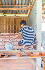 Workers masonry Clay brick to wall.