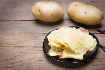 Potato chips heap on the black plate