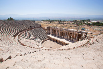 Fototapeta na wymiar Antique amphitheater in the ancient city of Hierapolis. Pamukkale, Turkey