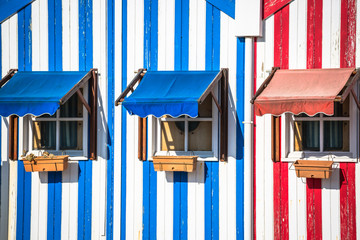 Colorful striped fishermen's houses in blue and red, Costa Nova,