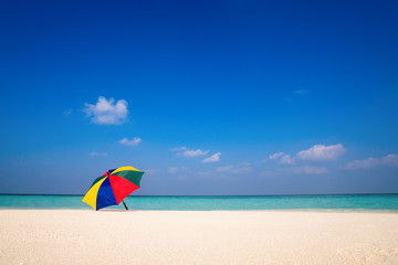 Beach umbrella on a sunny day, sea in background