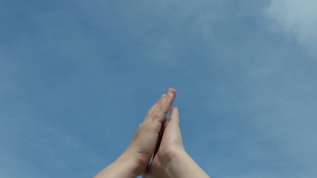 Hands against the sky.
