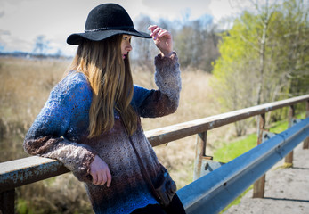 Beautiful girl on a walk over the bridge and the road, daring beauty