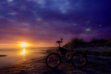 Fototapeta na wymiar Stationary bike at sunset sky beautifully.