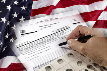Man with American citizenship application on USA flag - obrazy, fototapety, plakaty