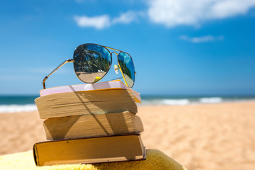 Livres et lunettes de soleil sur une plage