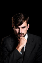 Handsome businessman on black background