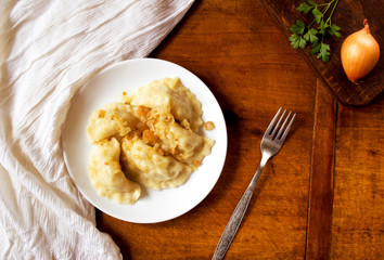 Homemade dumplings with vegetables and greaves