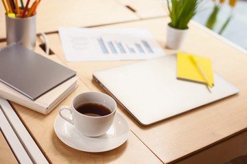 Hot drink with notebook on the table