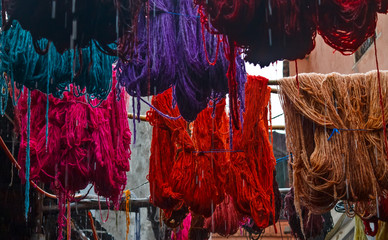 Colored dyed yarn is dried on the streets of Morocco
