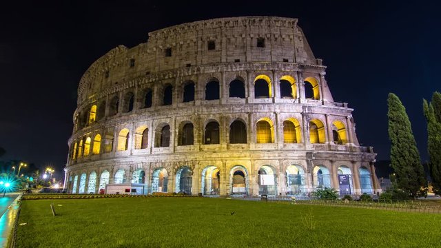 colosseum illuminated at night, time lapse dolly shot