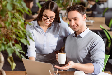 Positive colleagues using laptop