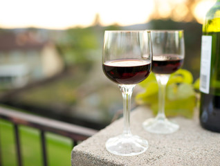 Pair of wine glasses in a outdoor setting. 