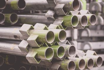 Close - up Stack of construction metal pipes .