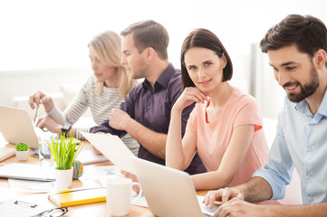 Cheerful creative team is working in cooperation