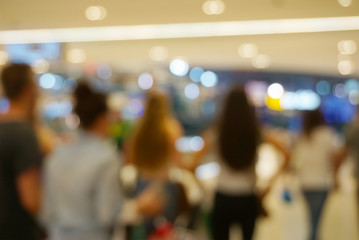 People shopping in mall. Defocused blur bokeh background.