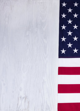 Folded USA flag on white wood background