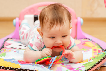 Happy little newborn baby with toys 