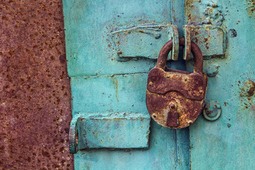 Old padlock on a blue door