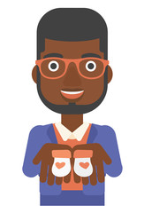 Man holding baby booties.