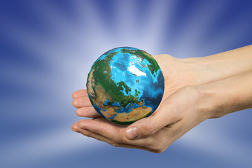Human hand holding globe