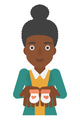 Pregnant woman with baby booties.