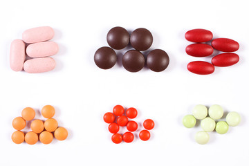 Colorful medical pills and capsules on white background, health care concept