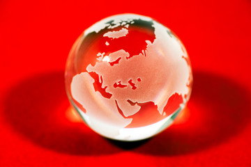 Crystal globe on red background © Sean K