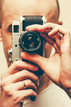 portrait of stylish handsome man with camera. film effect