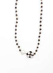 necklace with flower and black beads isolated close up