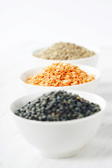Bowls of assorted dried lentils with red lentils, black beluga l