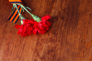 Symbols of Victory in Great Patriotic War two red flower and George ribbon