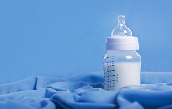 Baby milk bottle on a blue sheet